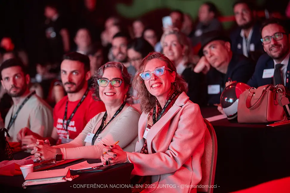 Plateia atenta em conferência BNI: a imersão coletiva que se reedita no Summit 2026